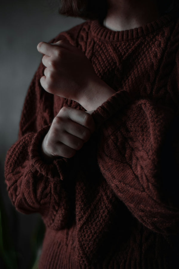 Hands holding a soft knitted wool textile