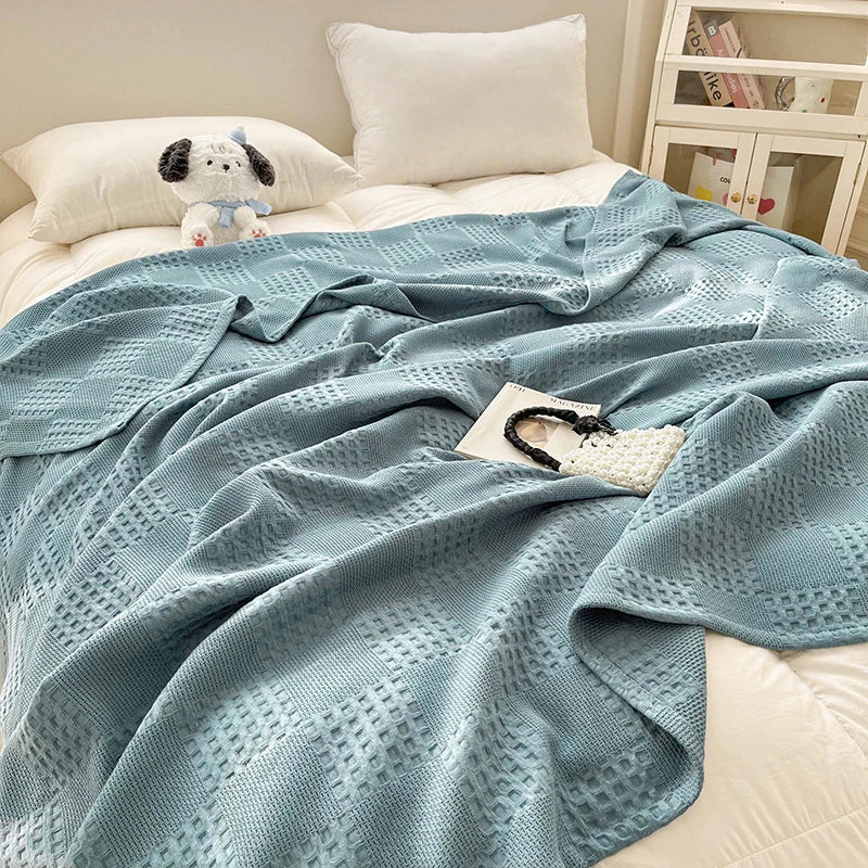 Assisi cotton waffle blanket on a bed