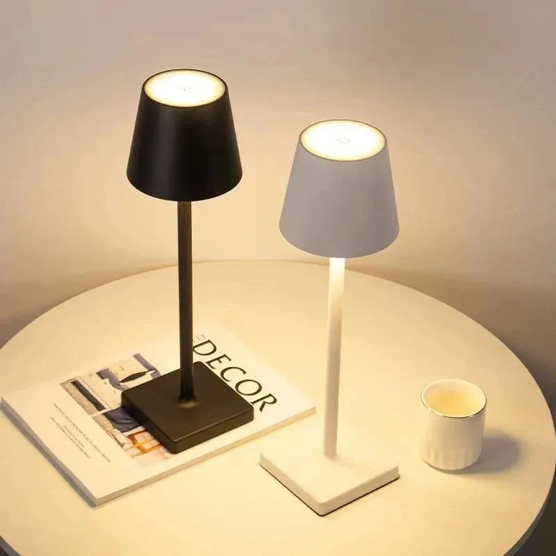 Bellagio cordless table lamps in Black and White glowing on a side table