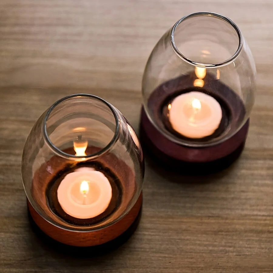 Faro glass candle holders glowing on a table