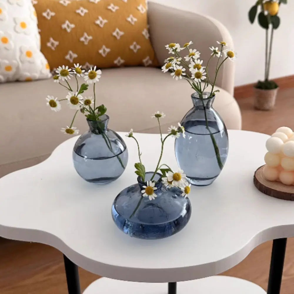 Goccia glass bud vases on a side table