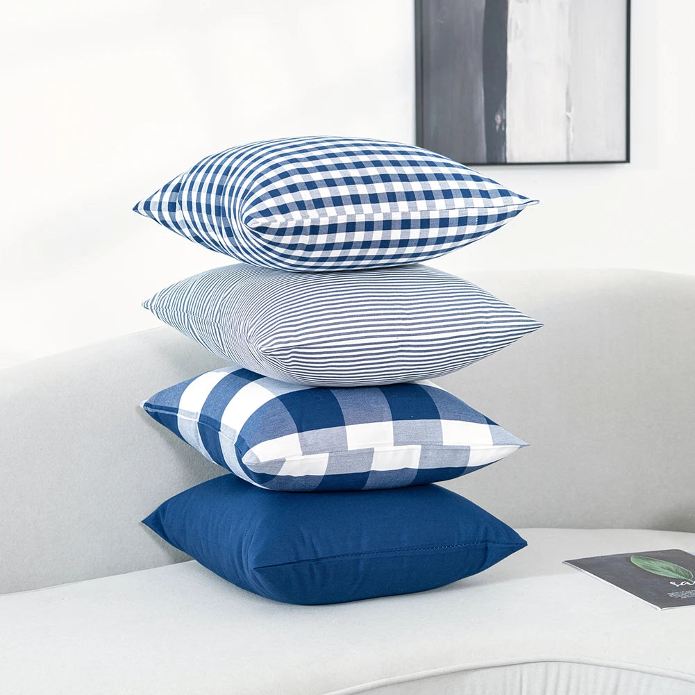 Stack of Quadretto navy cushion covers