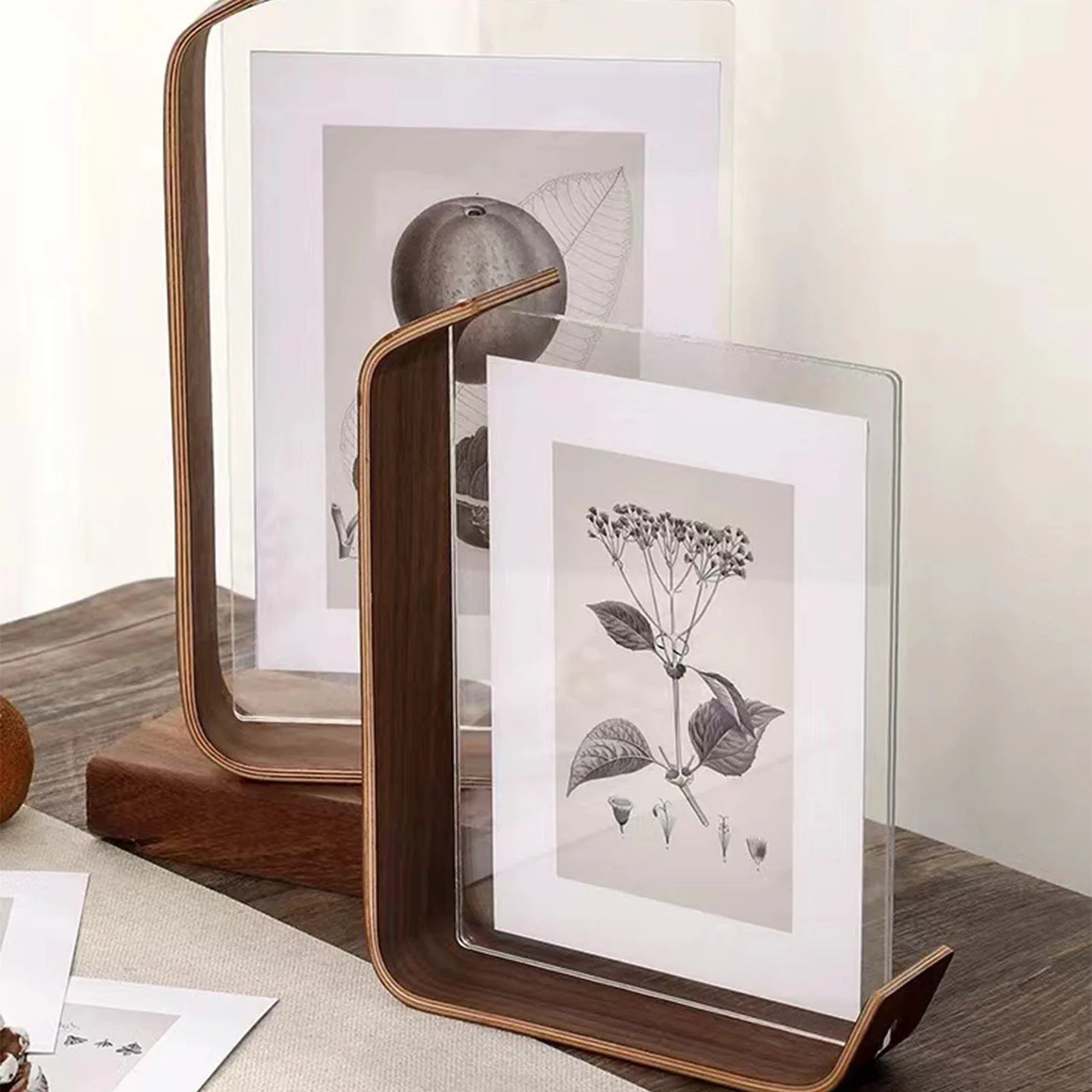 Teca acrylic frames with photos on a shelf